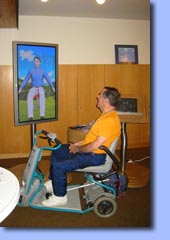 A man in a rollchair in front of the interactive mirror